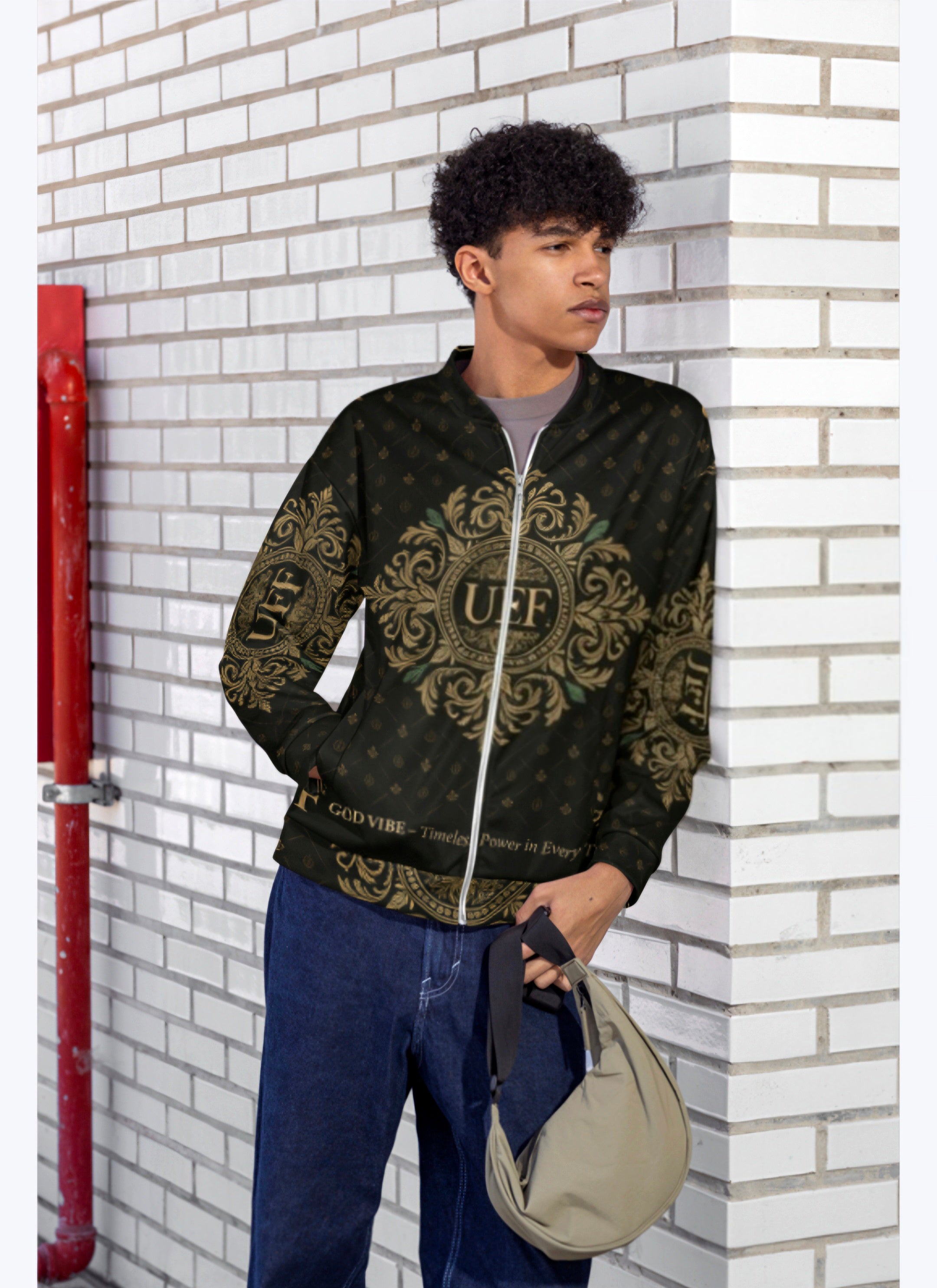 Person wearing a patterned jacket leaning against a white brick wall.